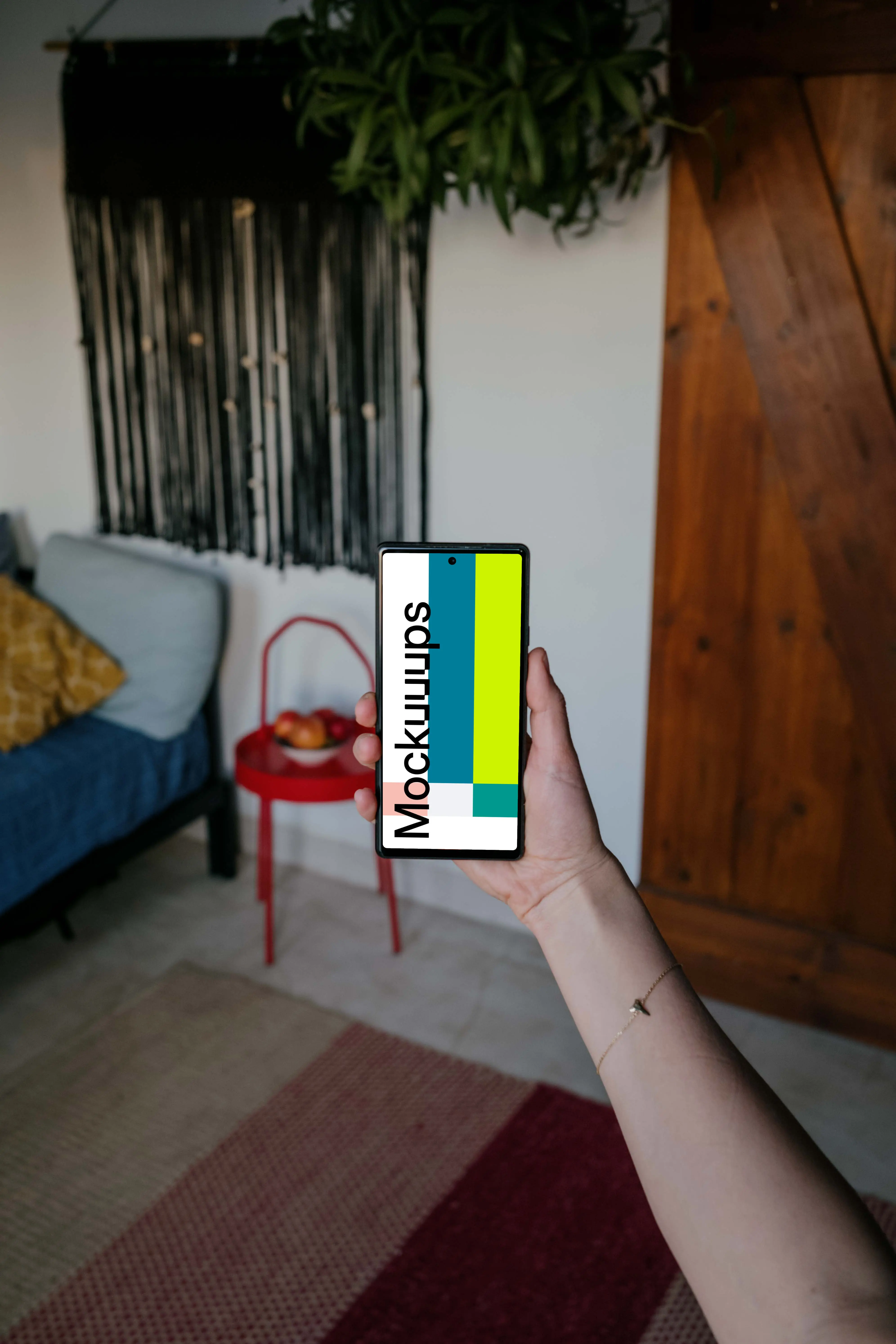 Pixel 6 mockup held by a user in a living room