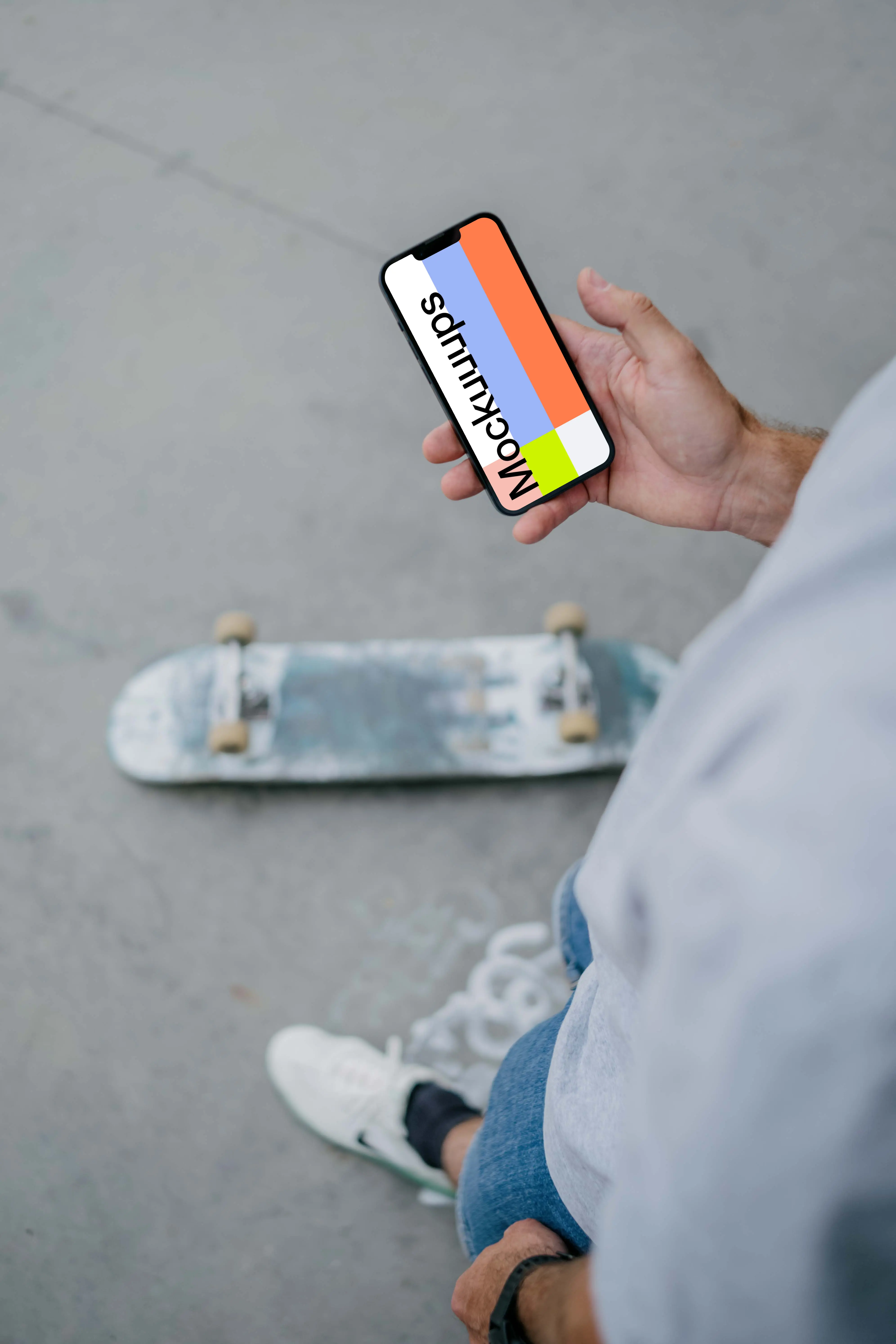 Skateboarder reading on phone mockup