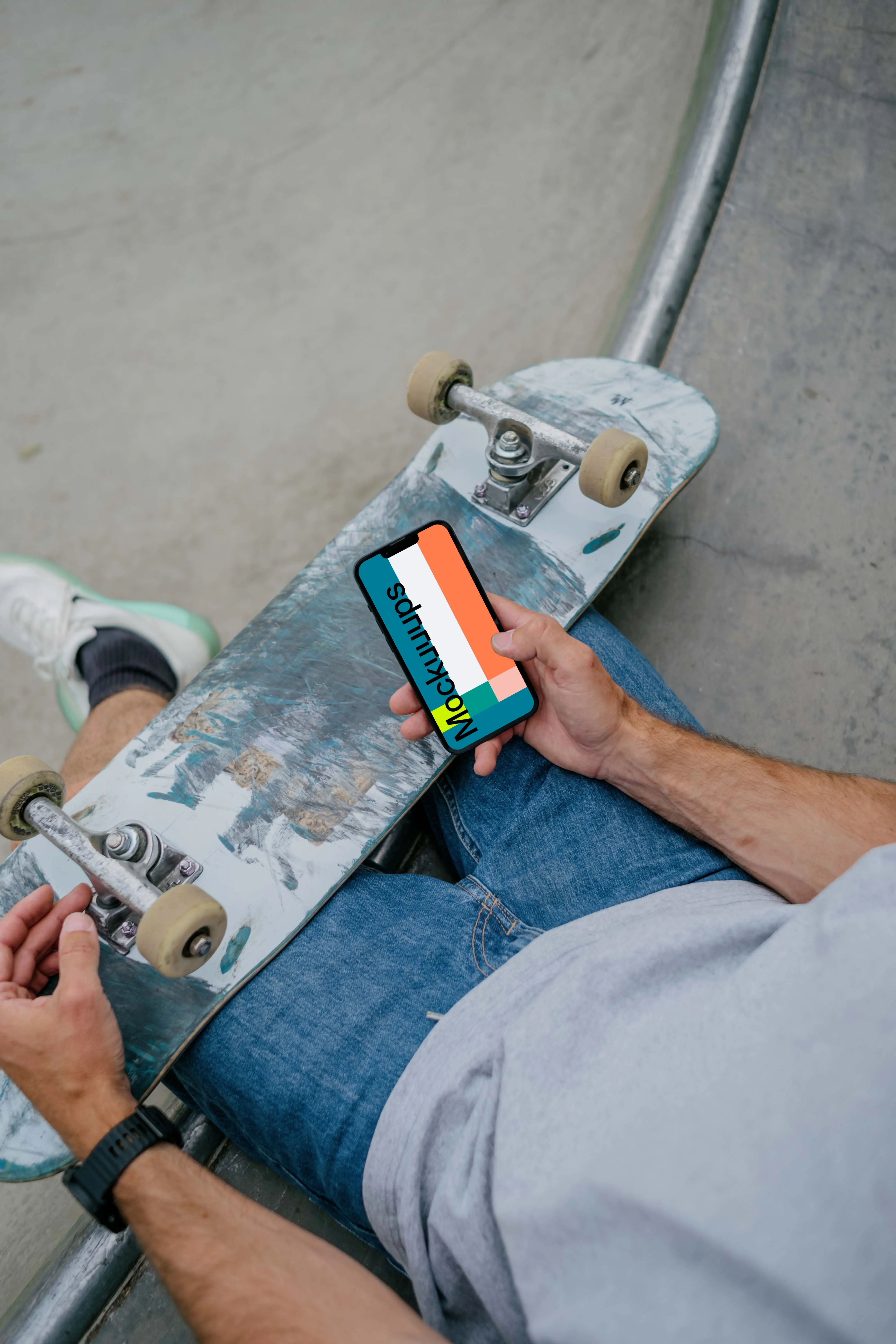 Skateboarder typing on an iPhone mockup