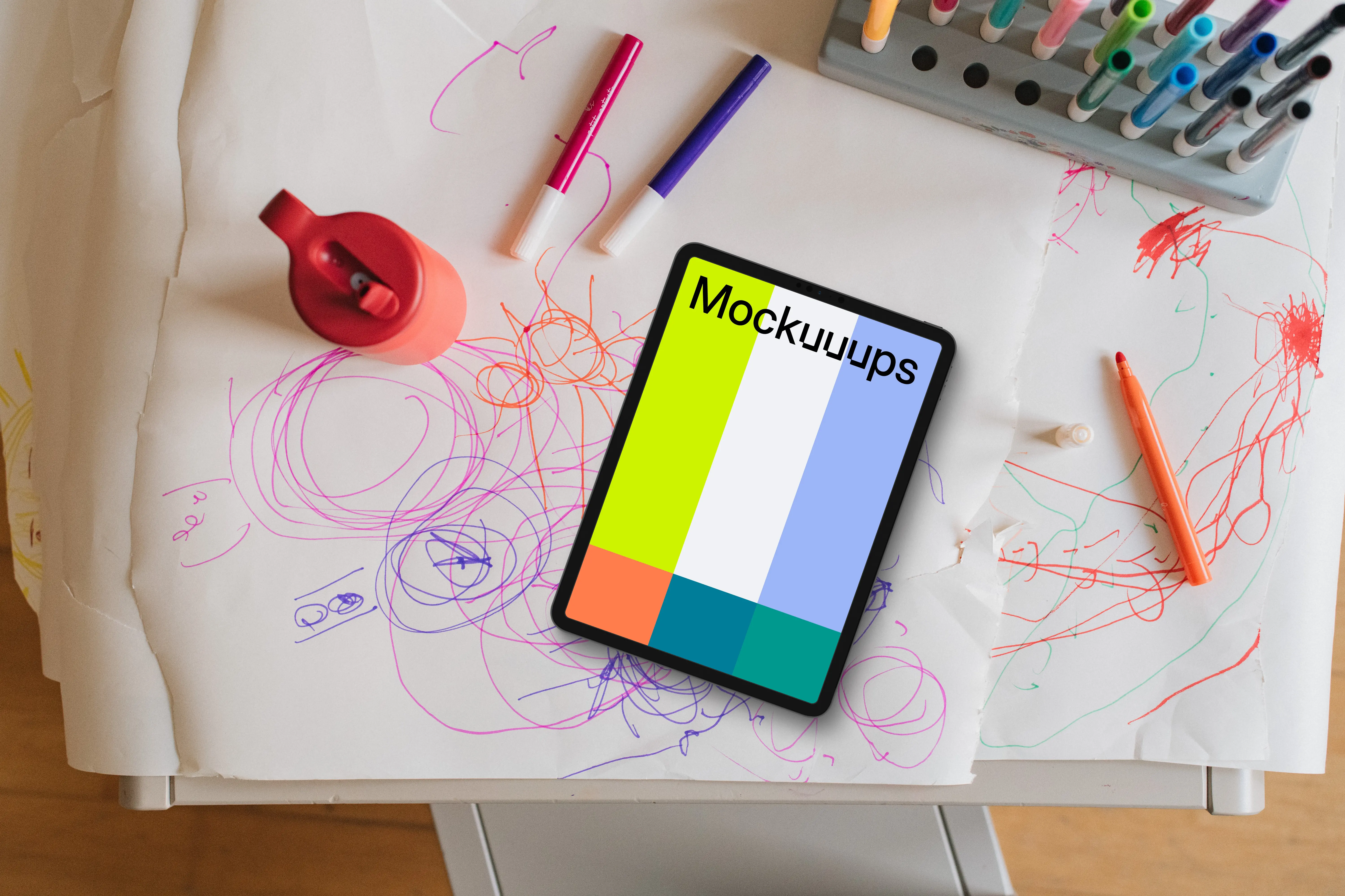 Tablet mockup on a child's drawing table