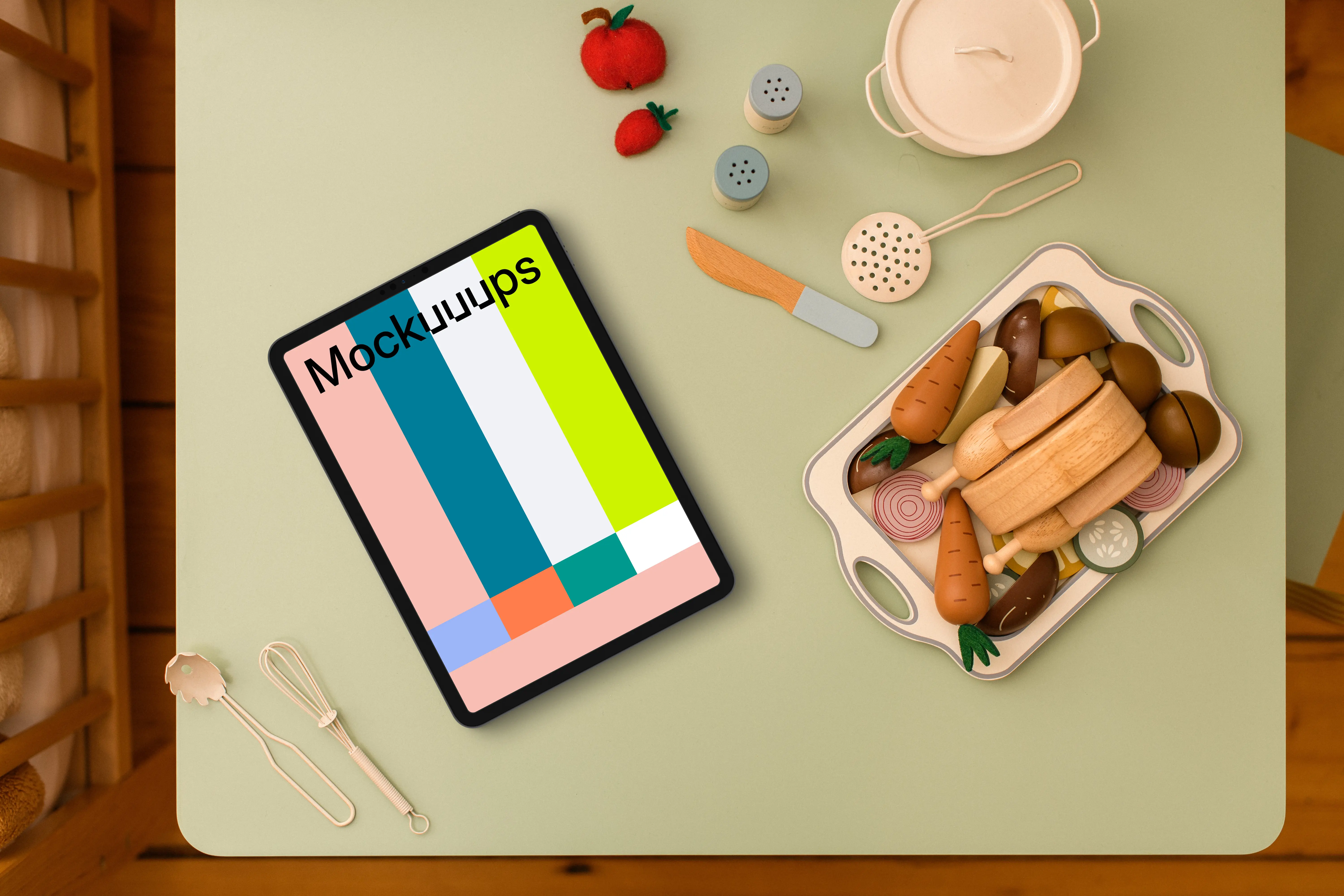Tablet mockup surrounded by children’s play kitchen set