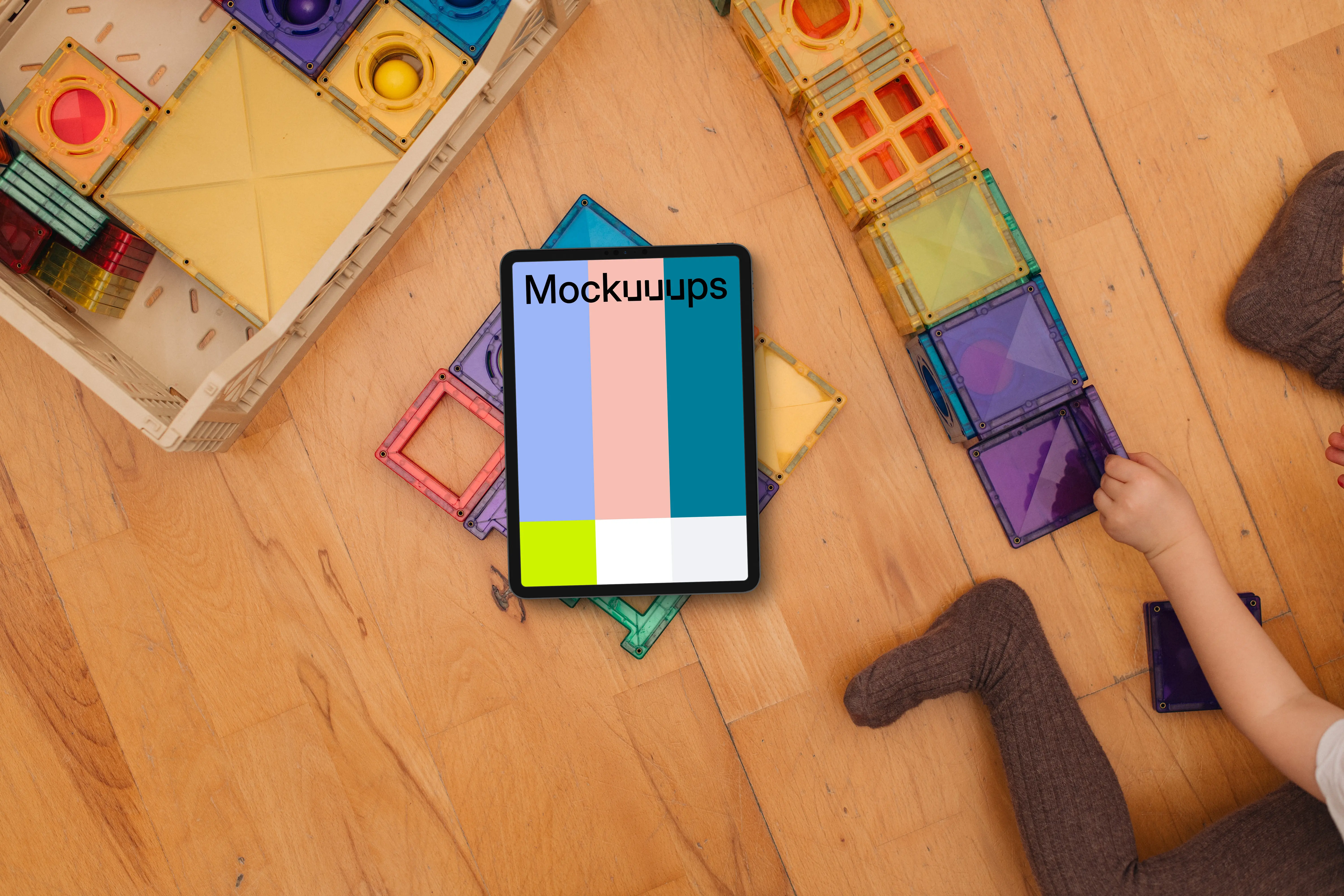 Tablet mockup surrounded by colorful children's blocks