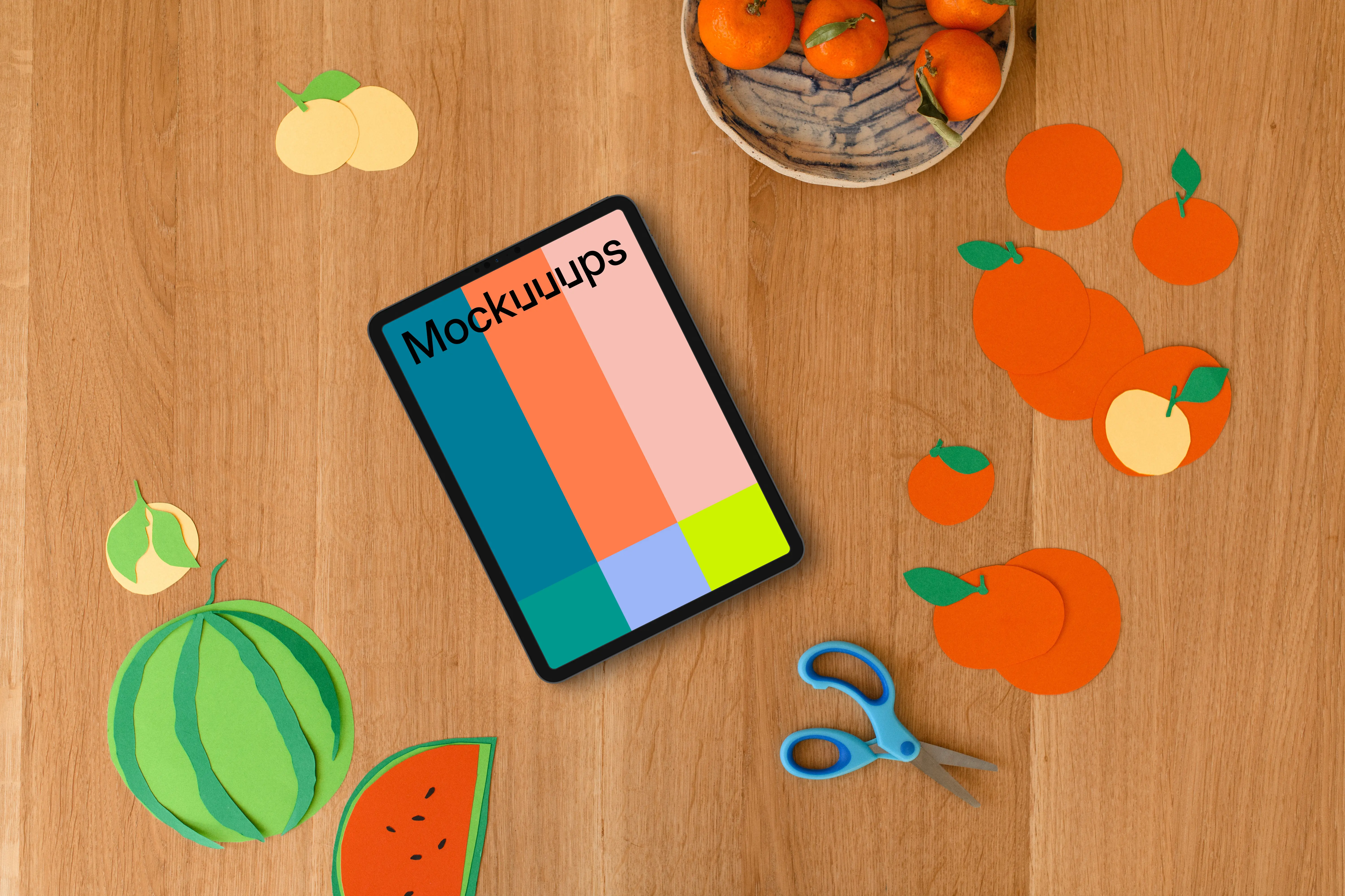 Tablet mockup surrounded by colorful paper fruit cutouts