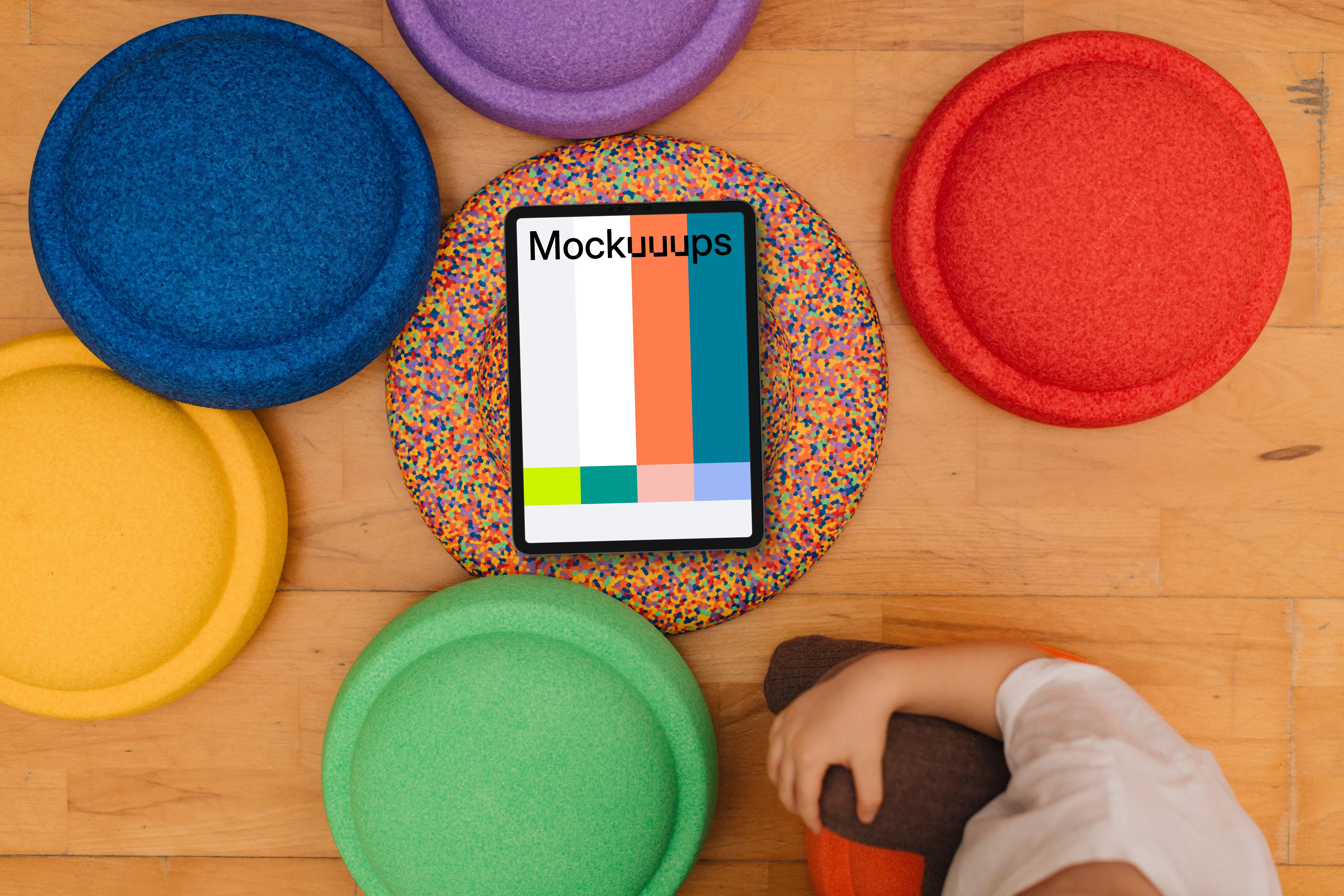 Tablet mockup surrounded by colorful sitting pads