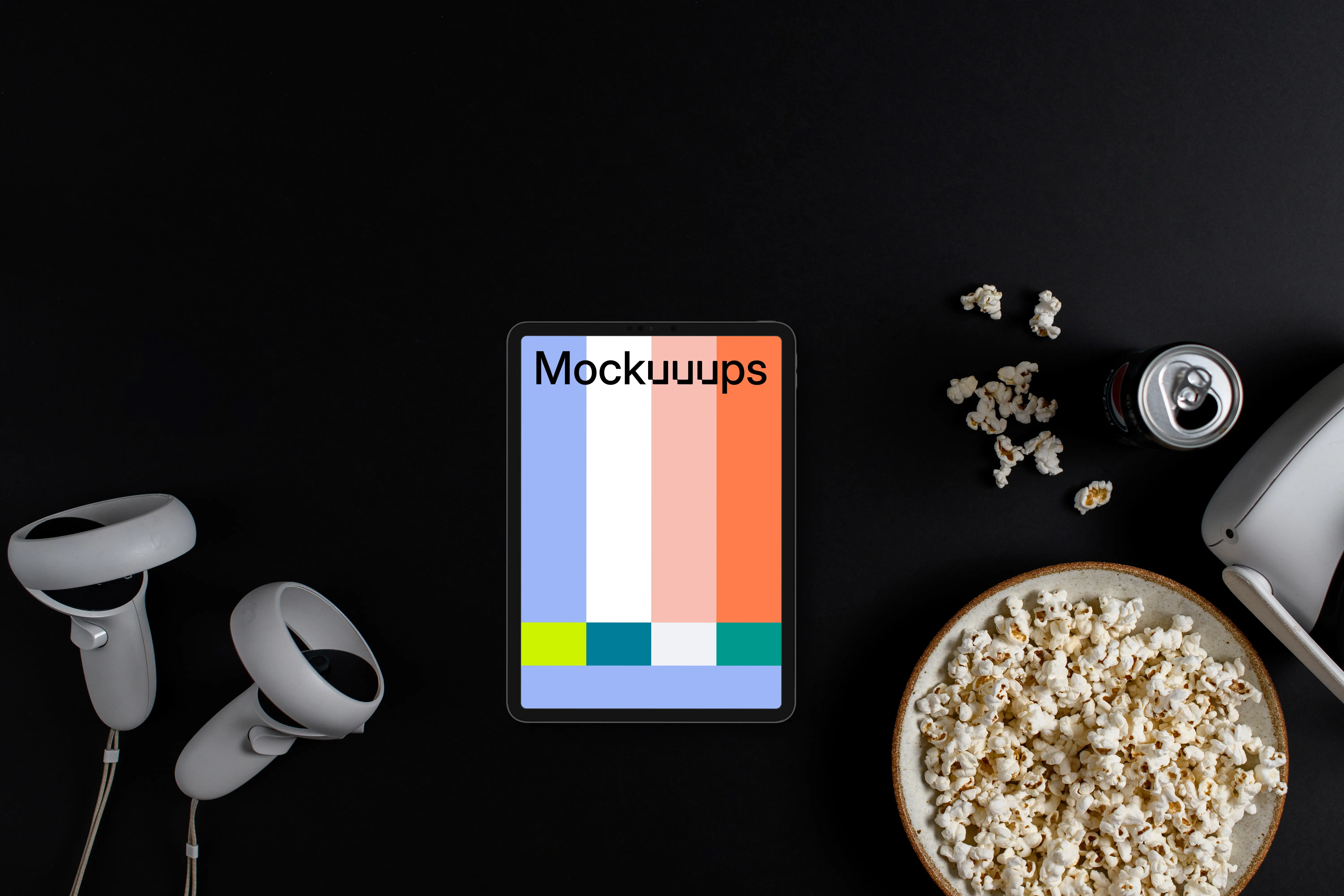 Tablet mockup with entertainment accessories on a dark background