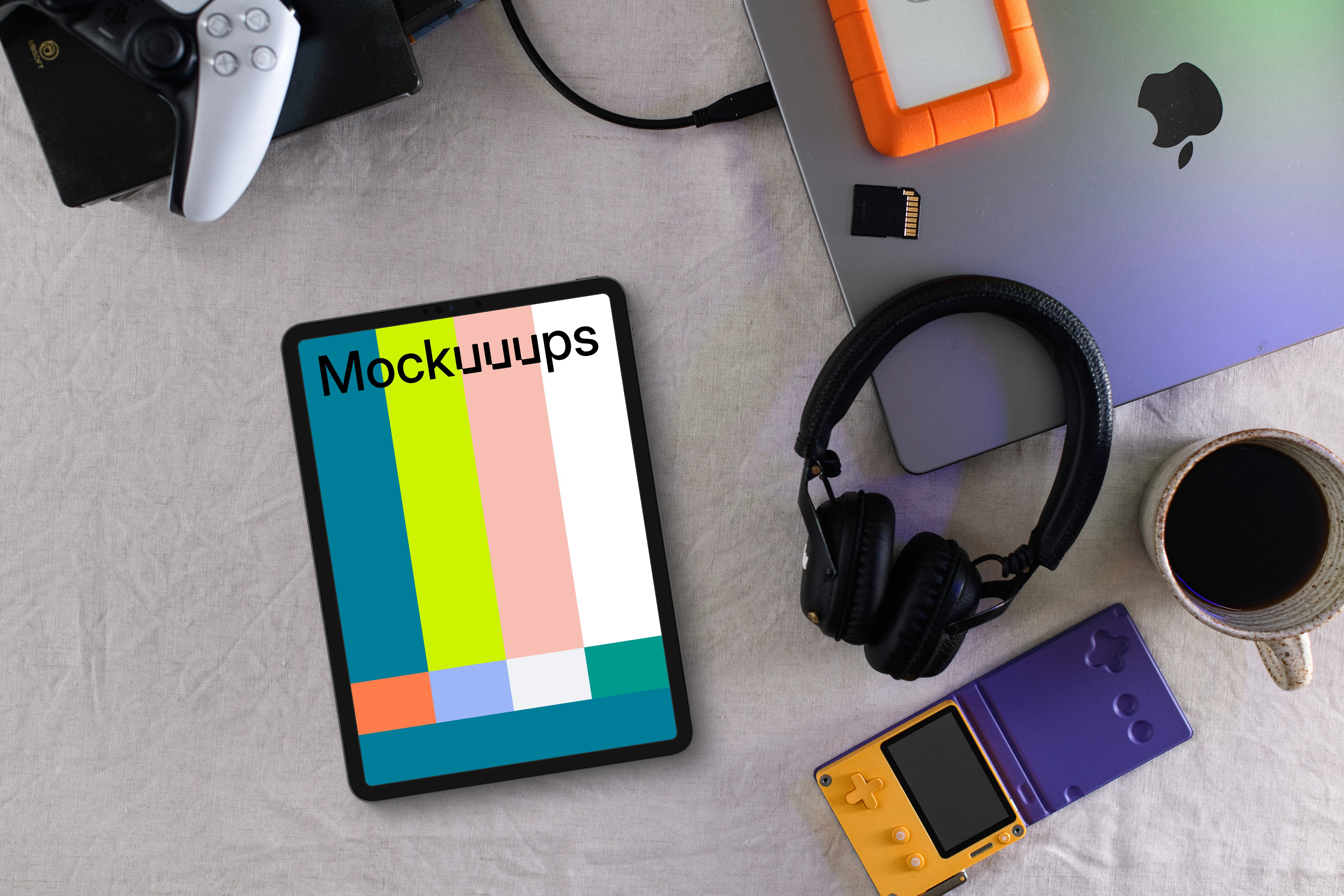 Tablet mockup with gaming devices and laptop on a modern desk