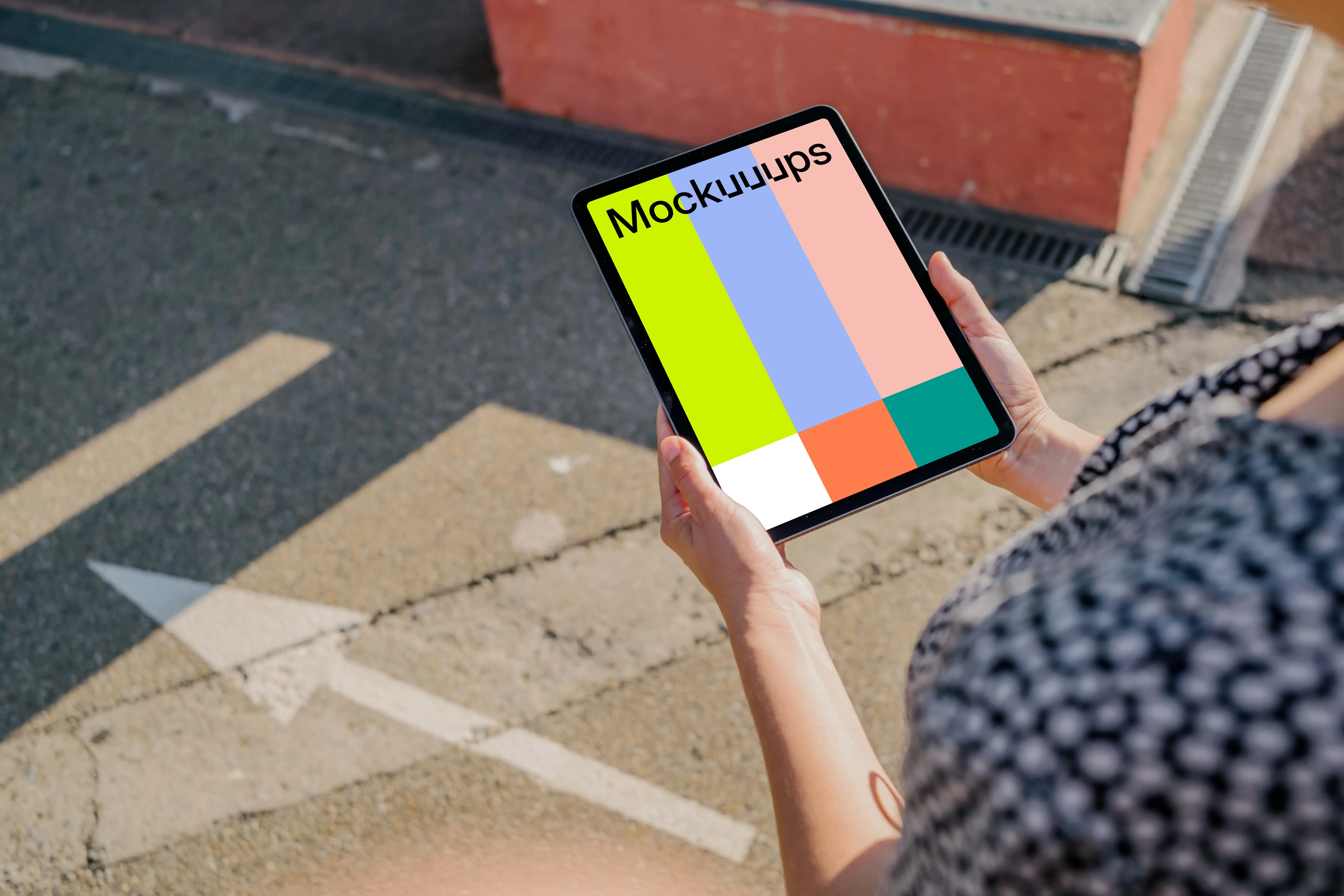 User holding an iPad Air mockup