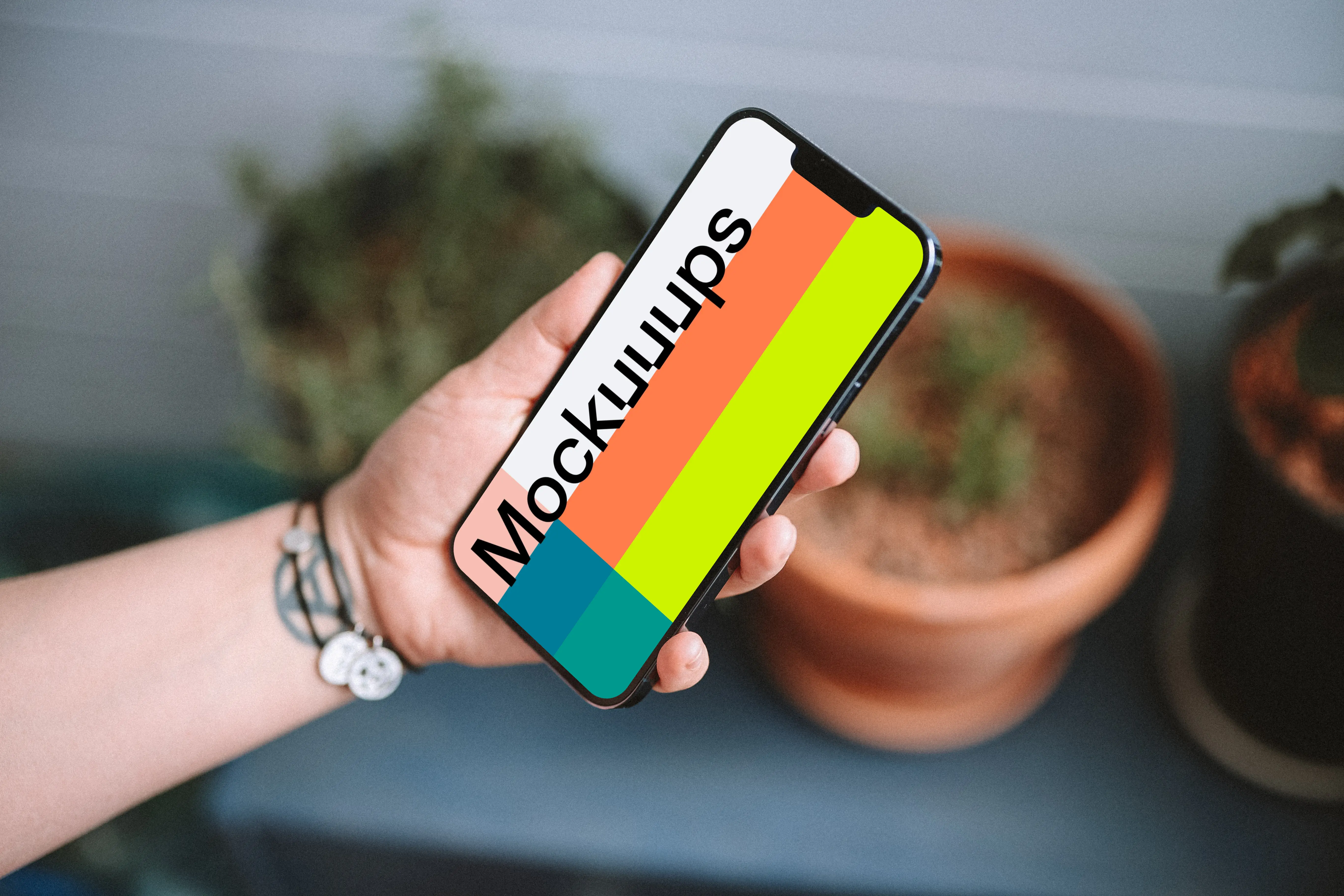 User holding an iPhone 13 mockup