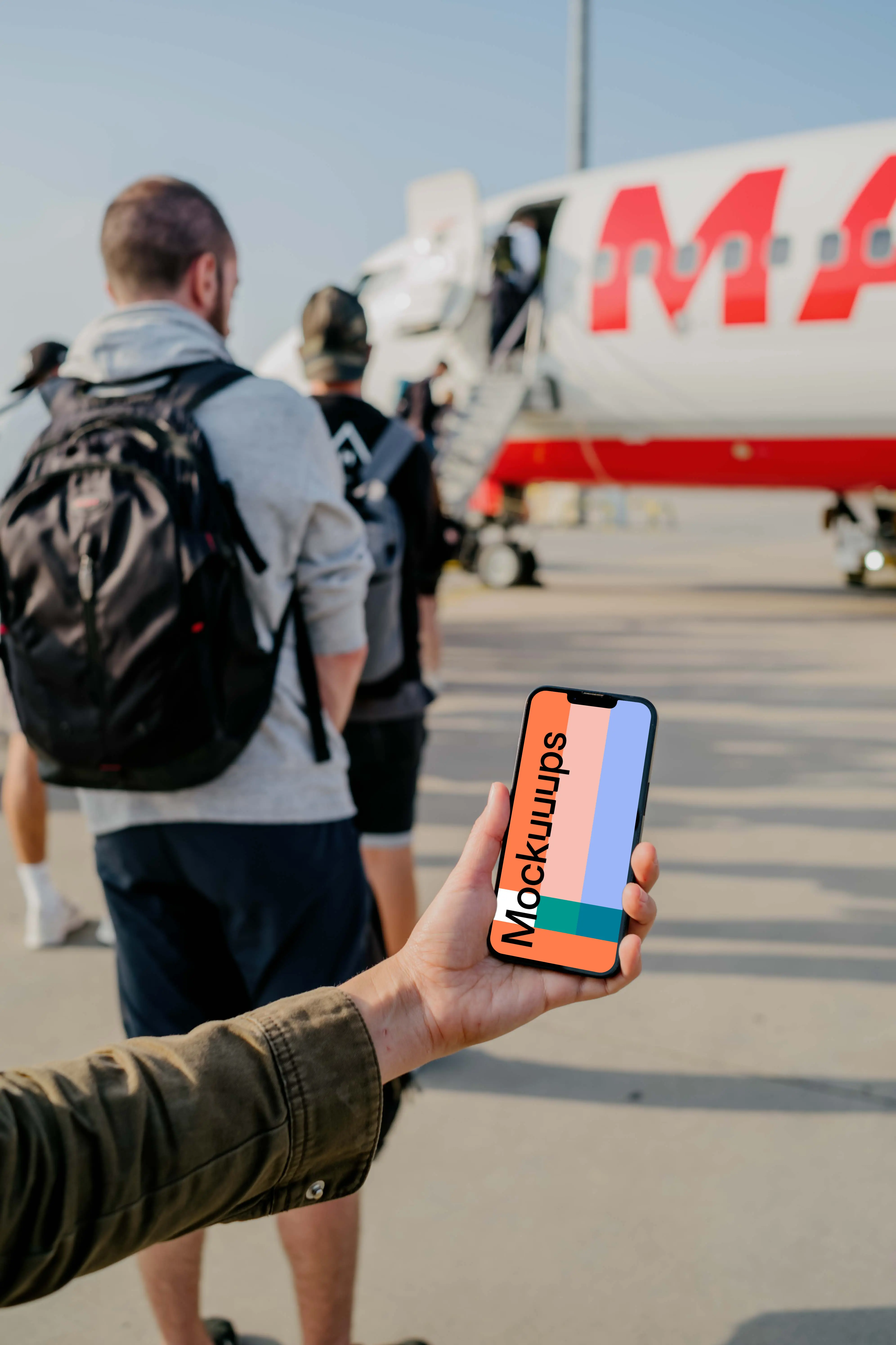 User's hand holding a phone mockup