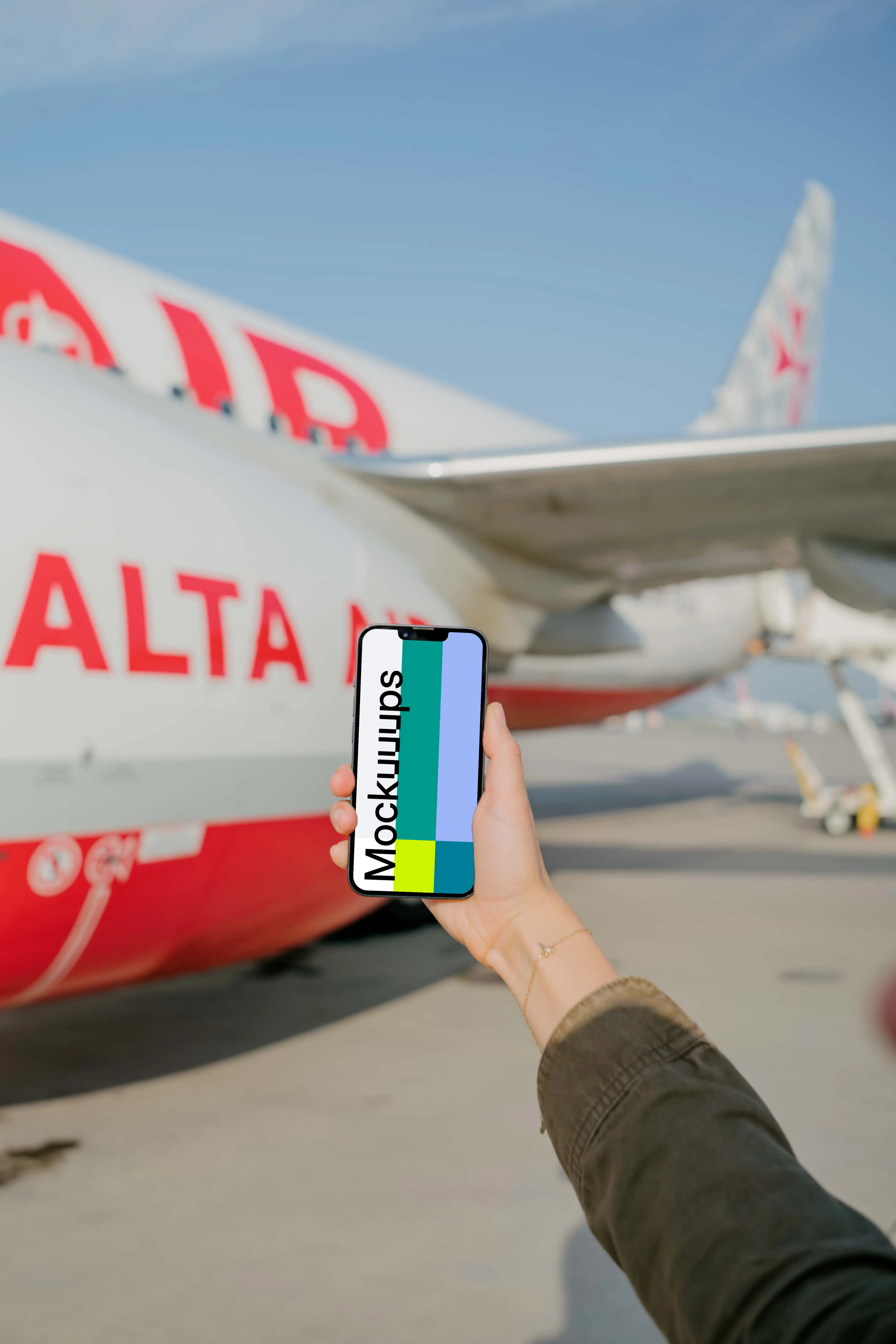 User's hand holding an iPhone mockup