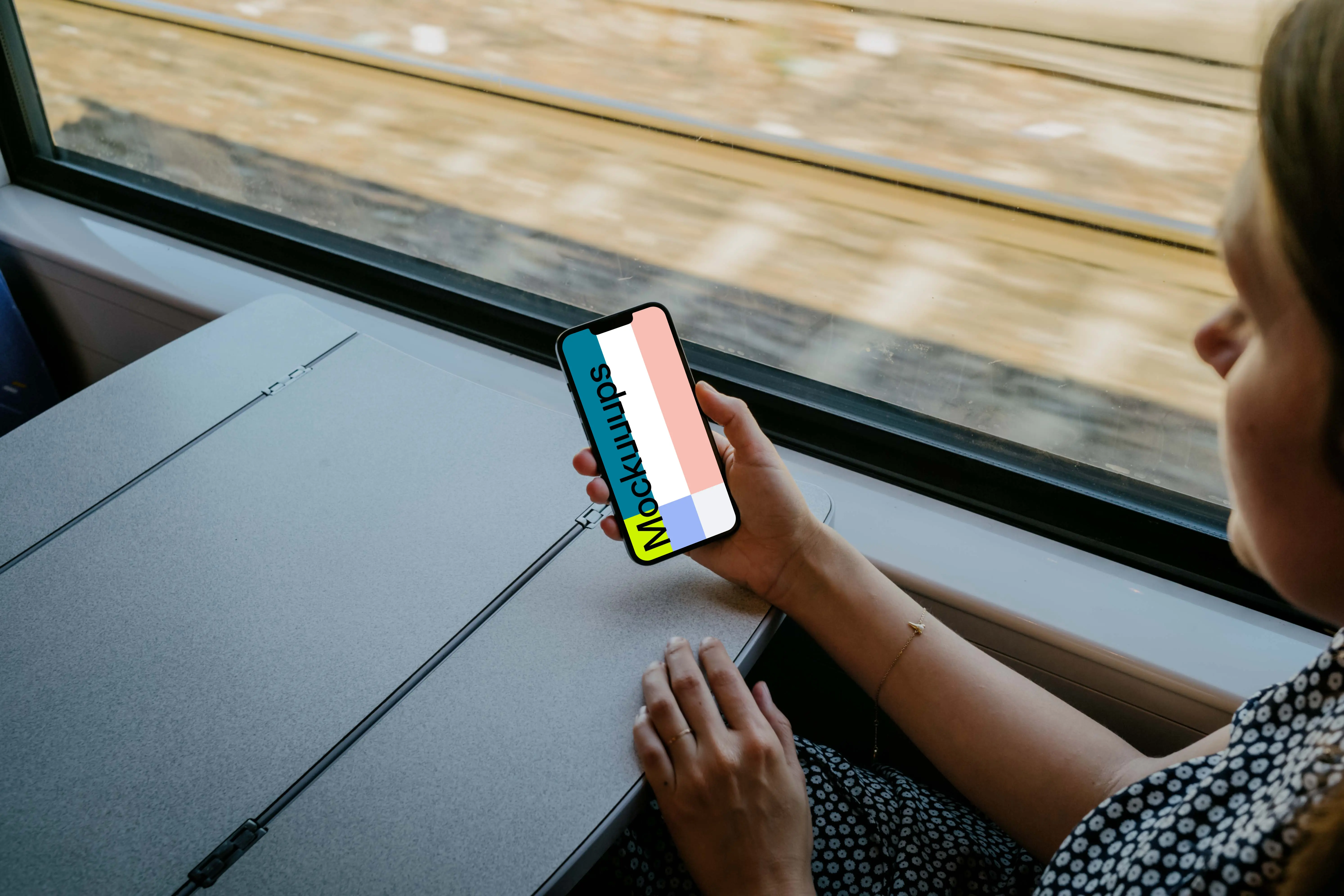 Woman hand holding an iPhone 13 mockup