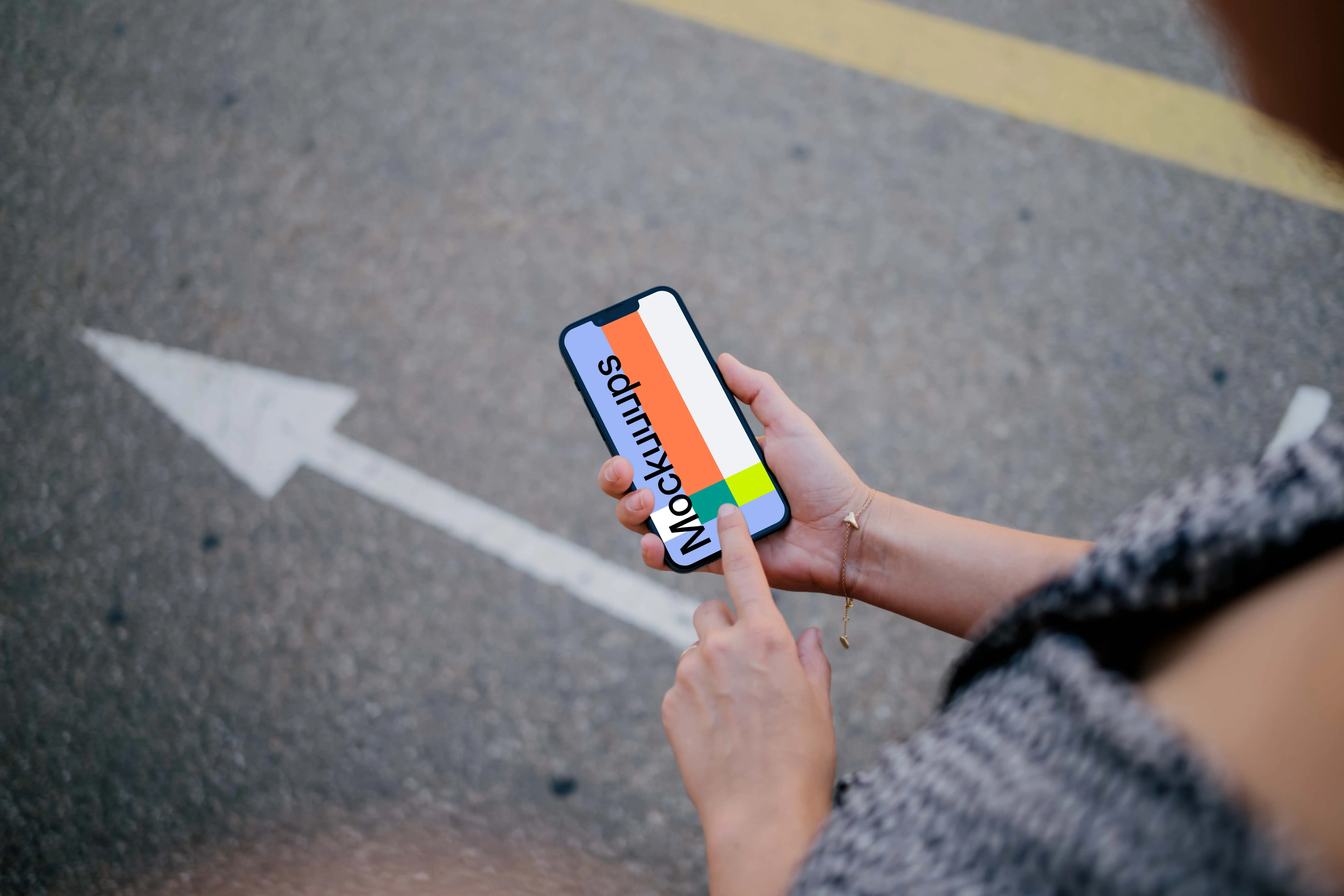 Woman hand pointing on an iPhone 13 mockup
