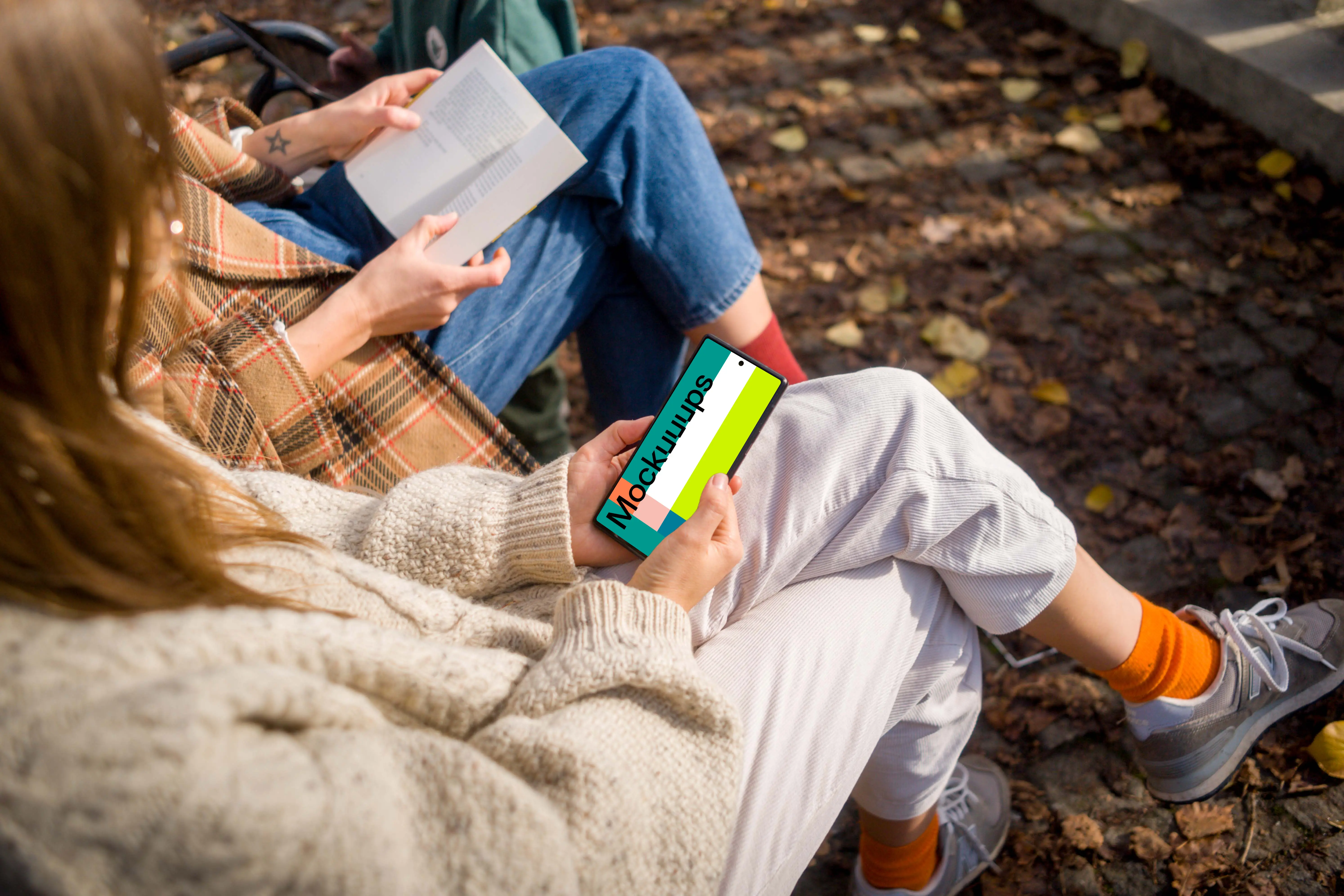 Woman holding a Google Pixel 6 in autumn park mockup