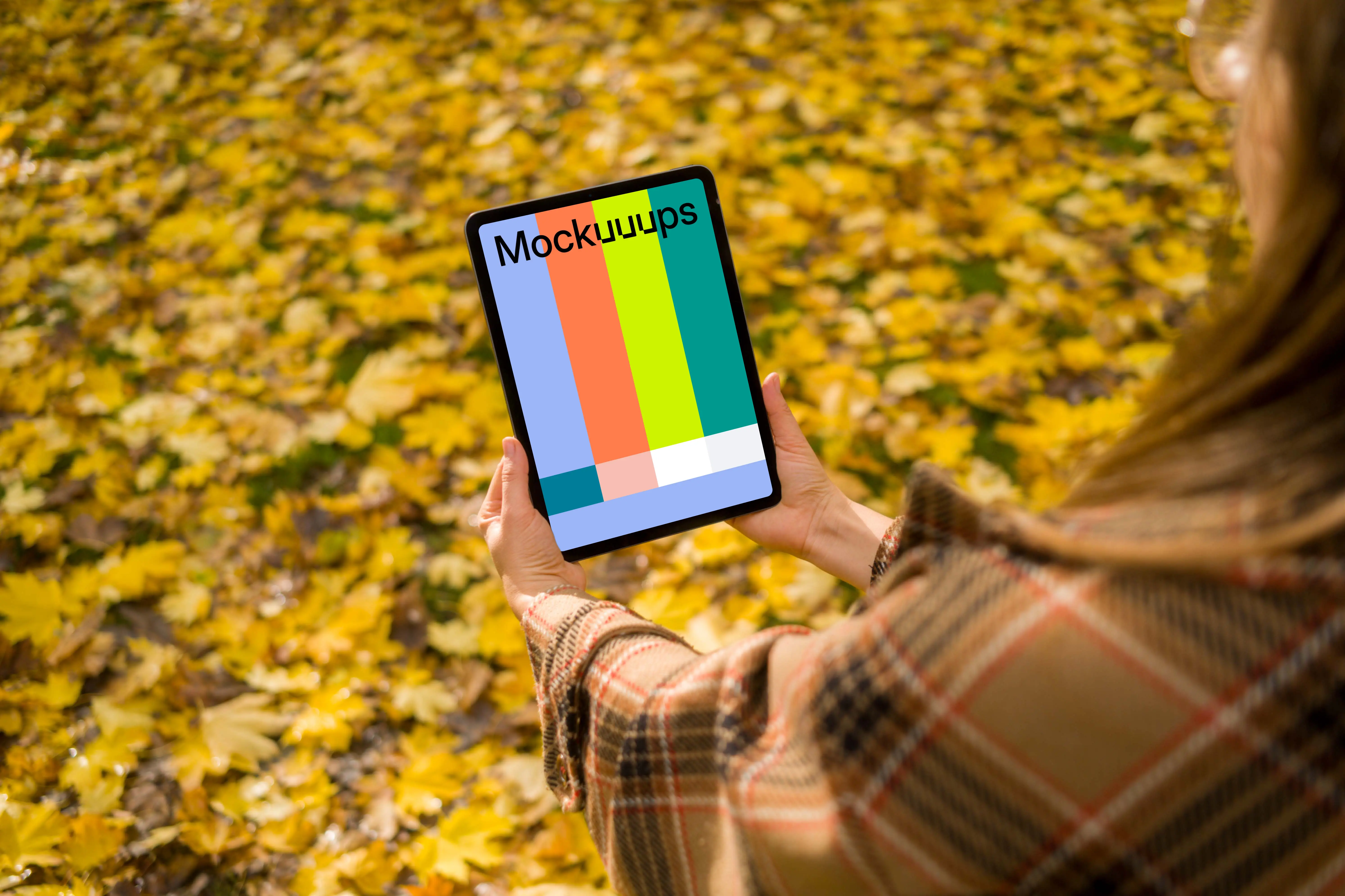 Woman holding an iPad Air in autumn vibe mockup