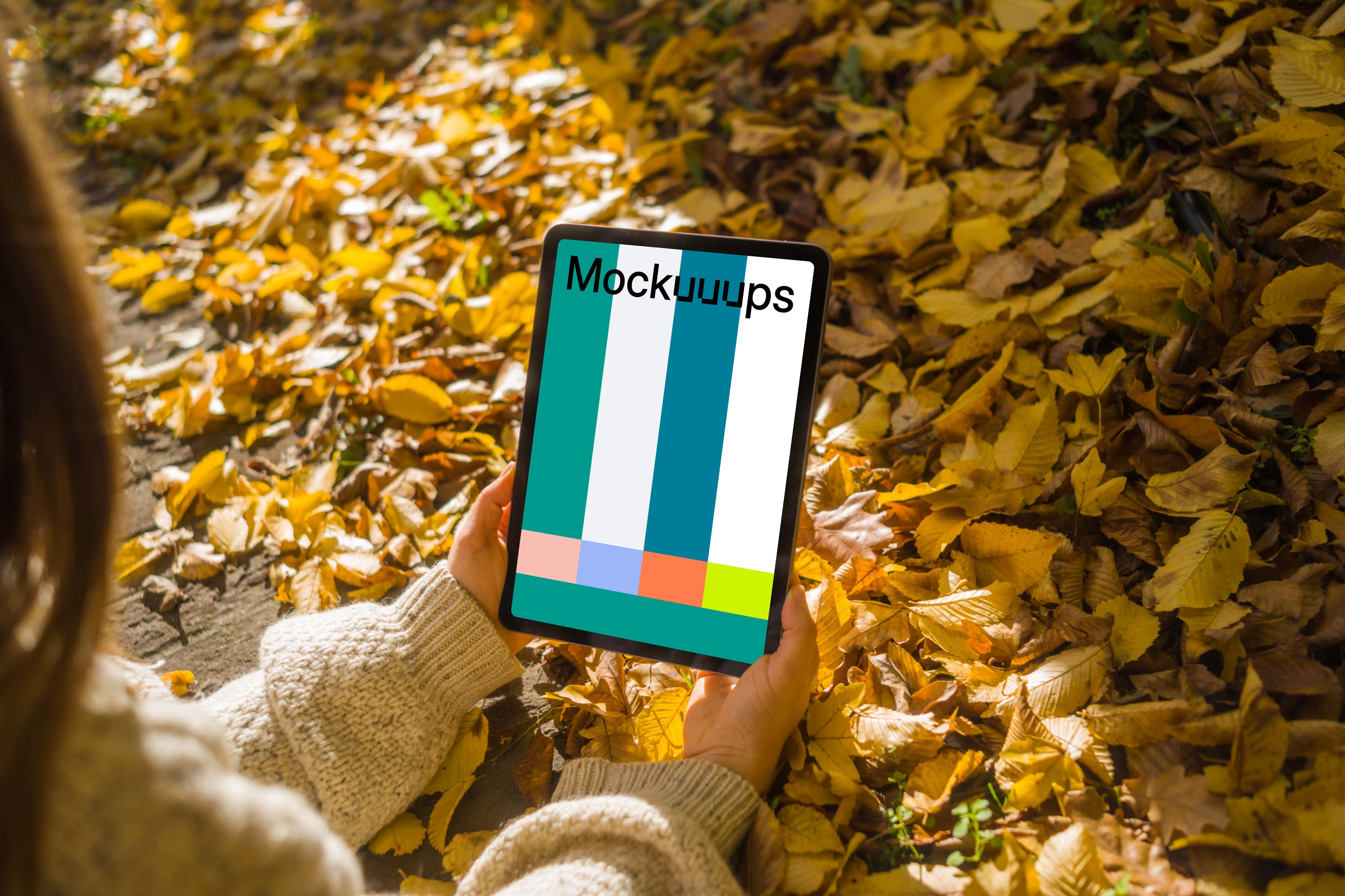 Woman holding an iPad Air in the leaves mockup