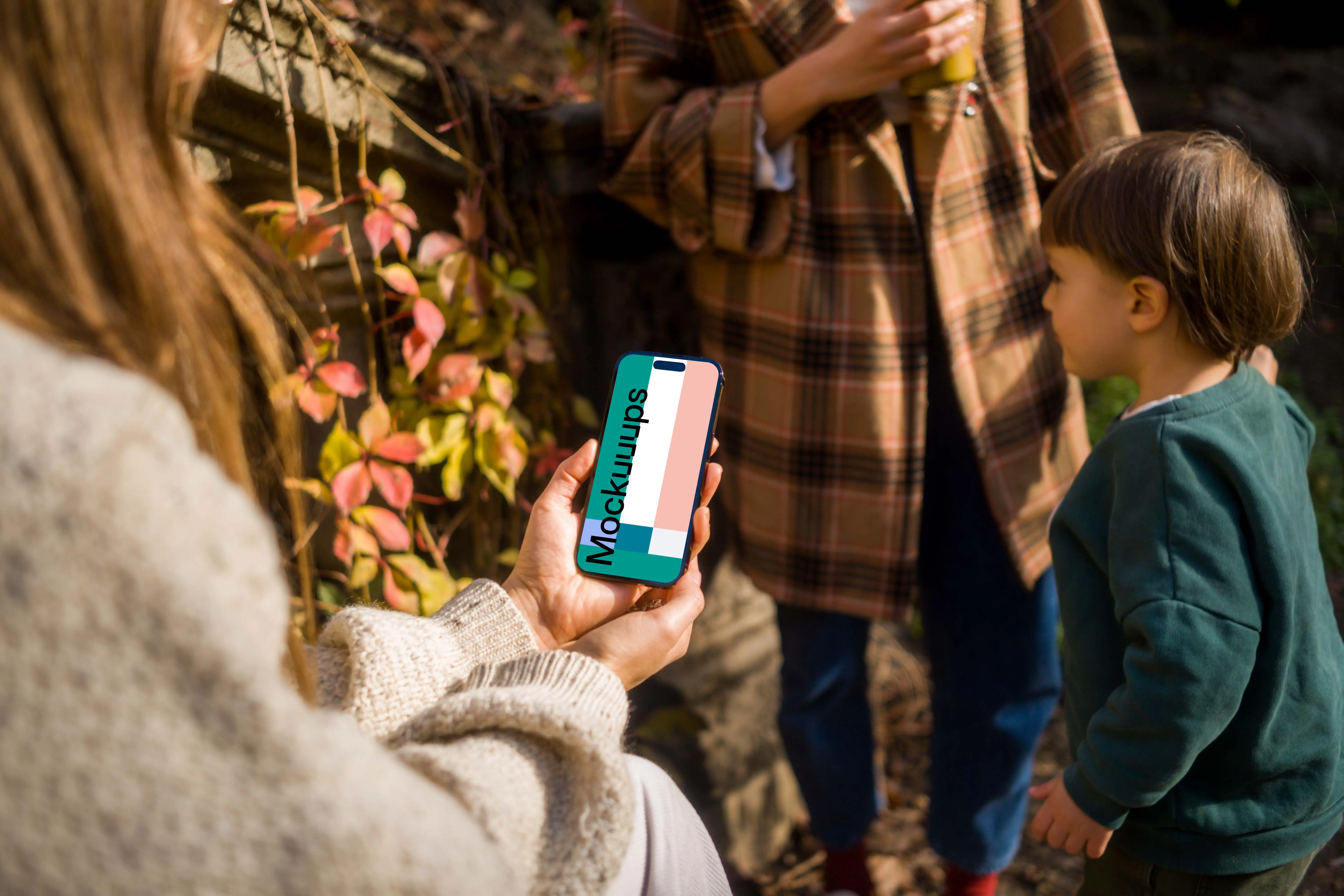Woman holding an iPhone 14 Pro in garden mockup