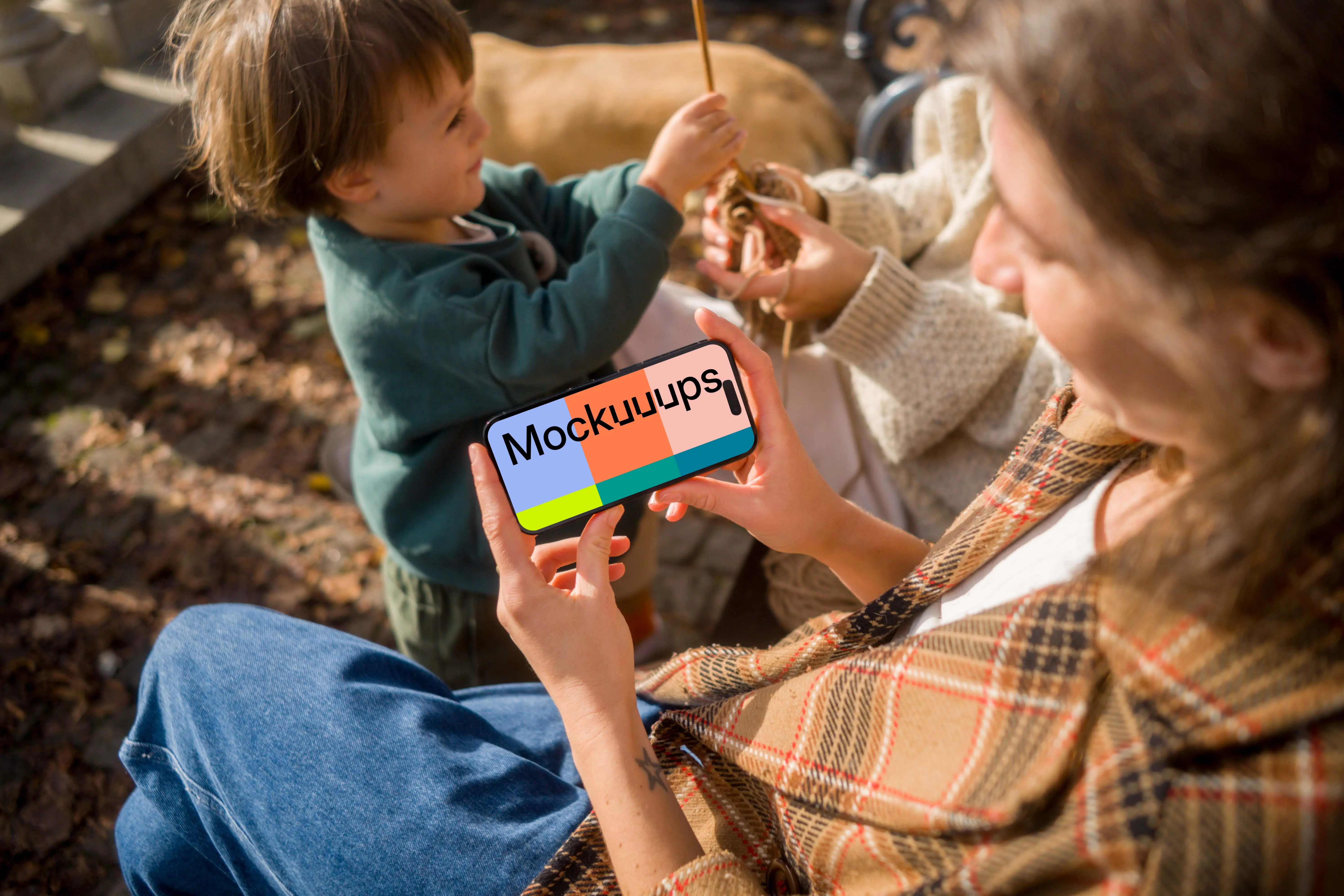 Woman holding an iPhone 14 Pro while sitting on a bench mockup