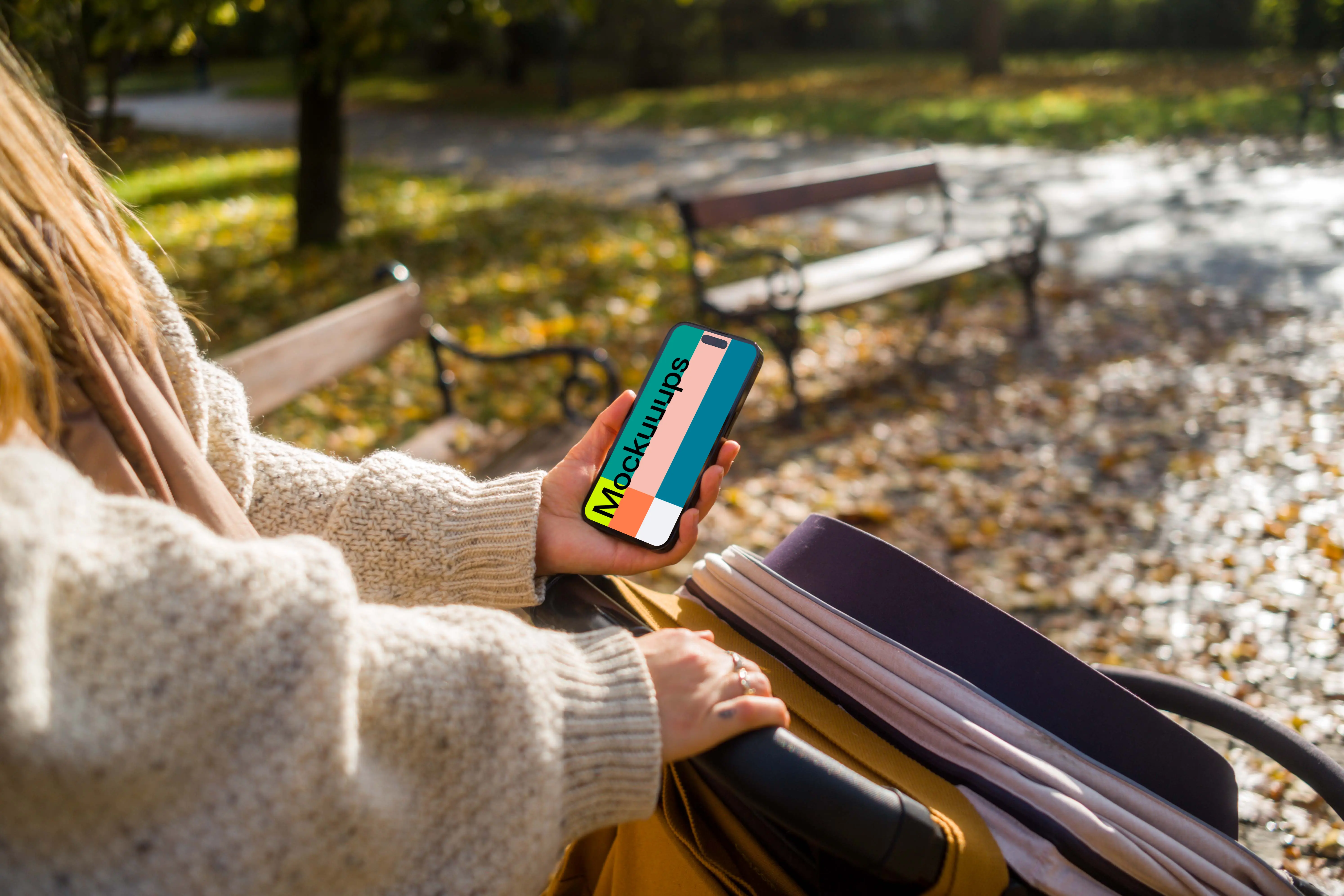 Woman holding an iPhone while walking in a park mockup