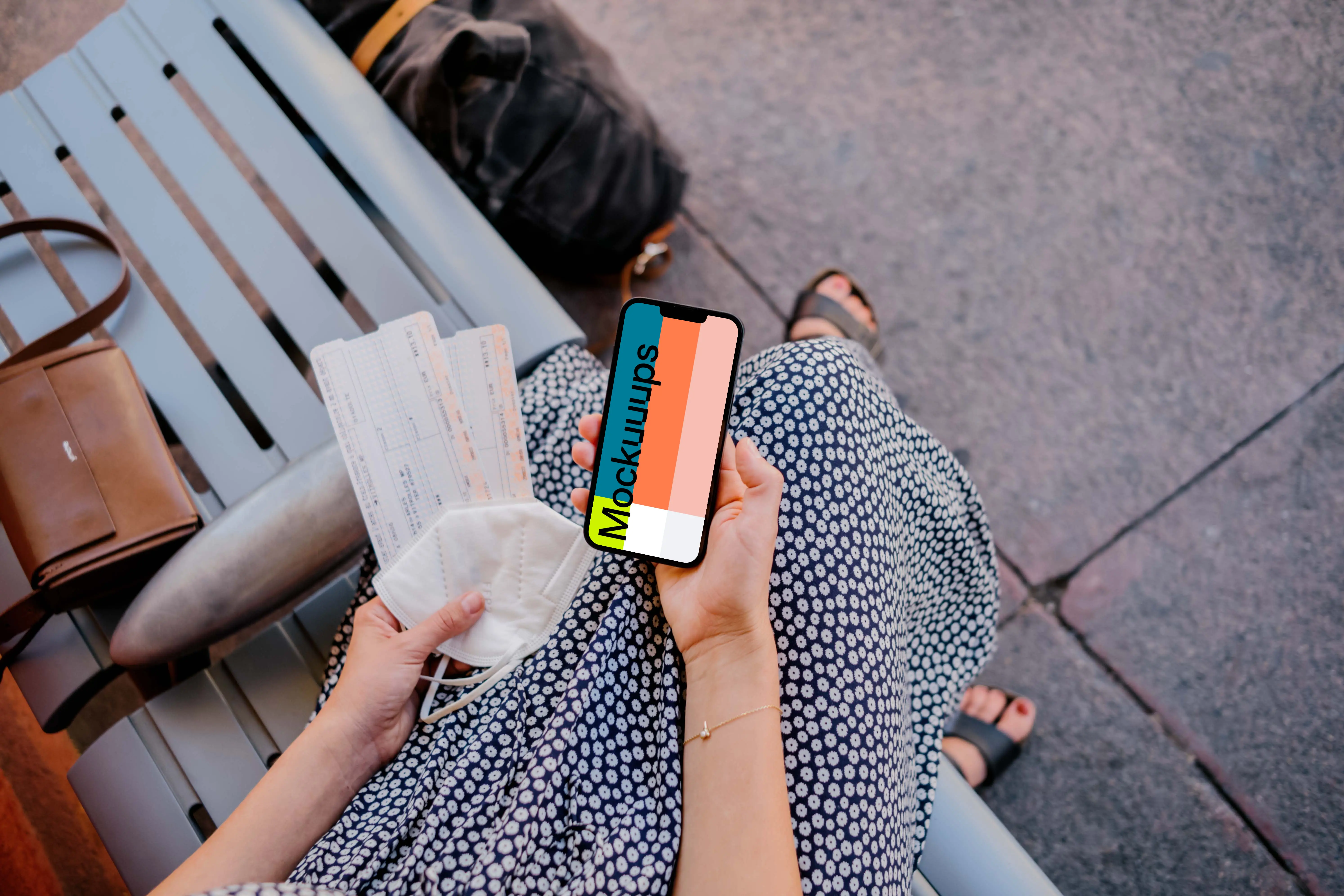 Woman holding iPhone mockup and train tickets