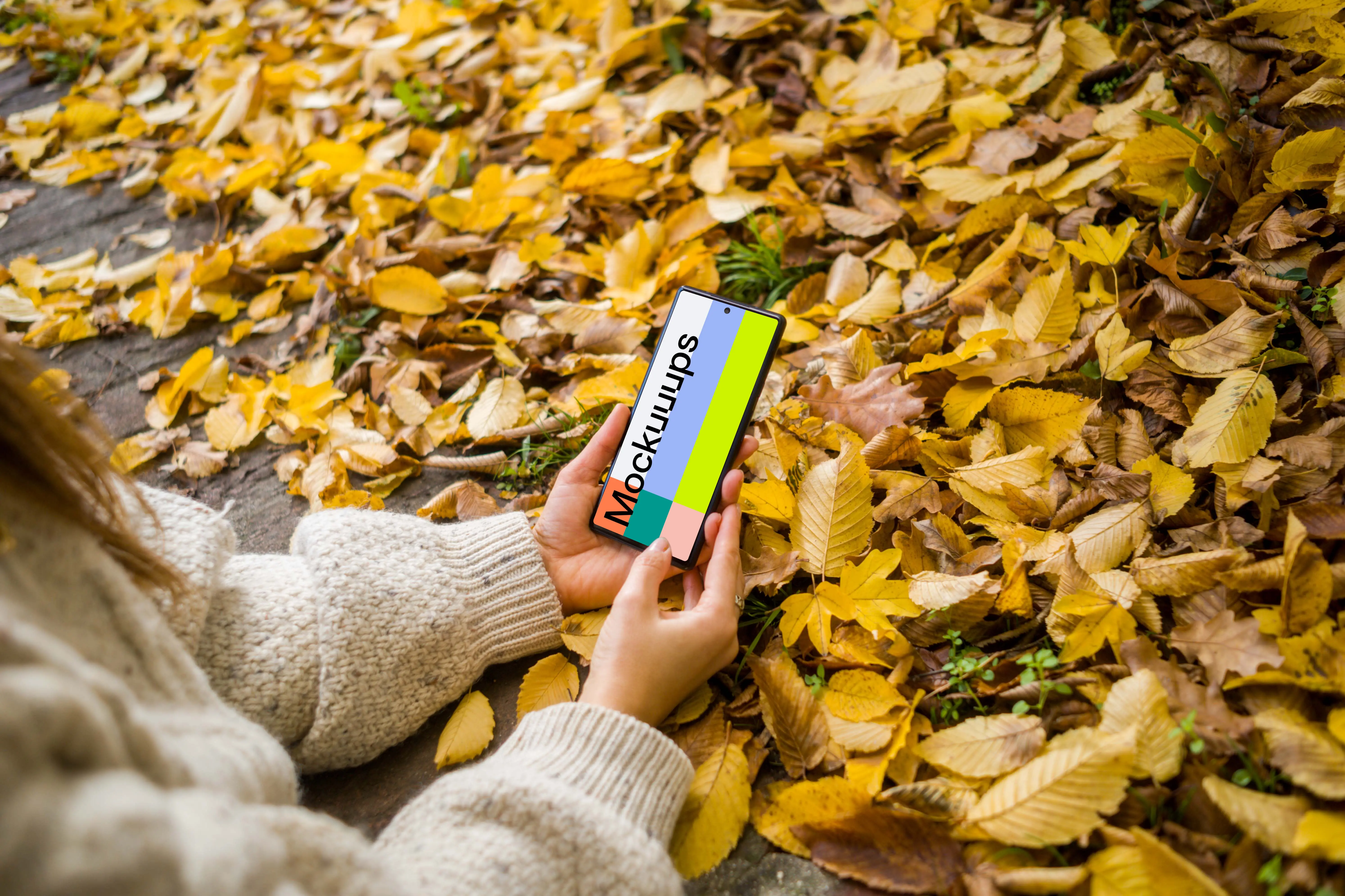 Woman typing on a Google Pixel with autumn styling mockup