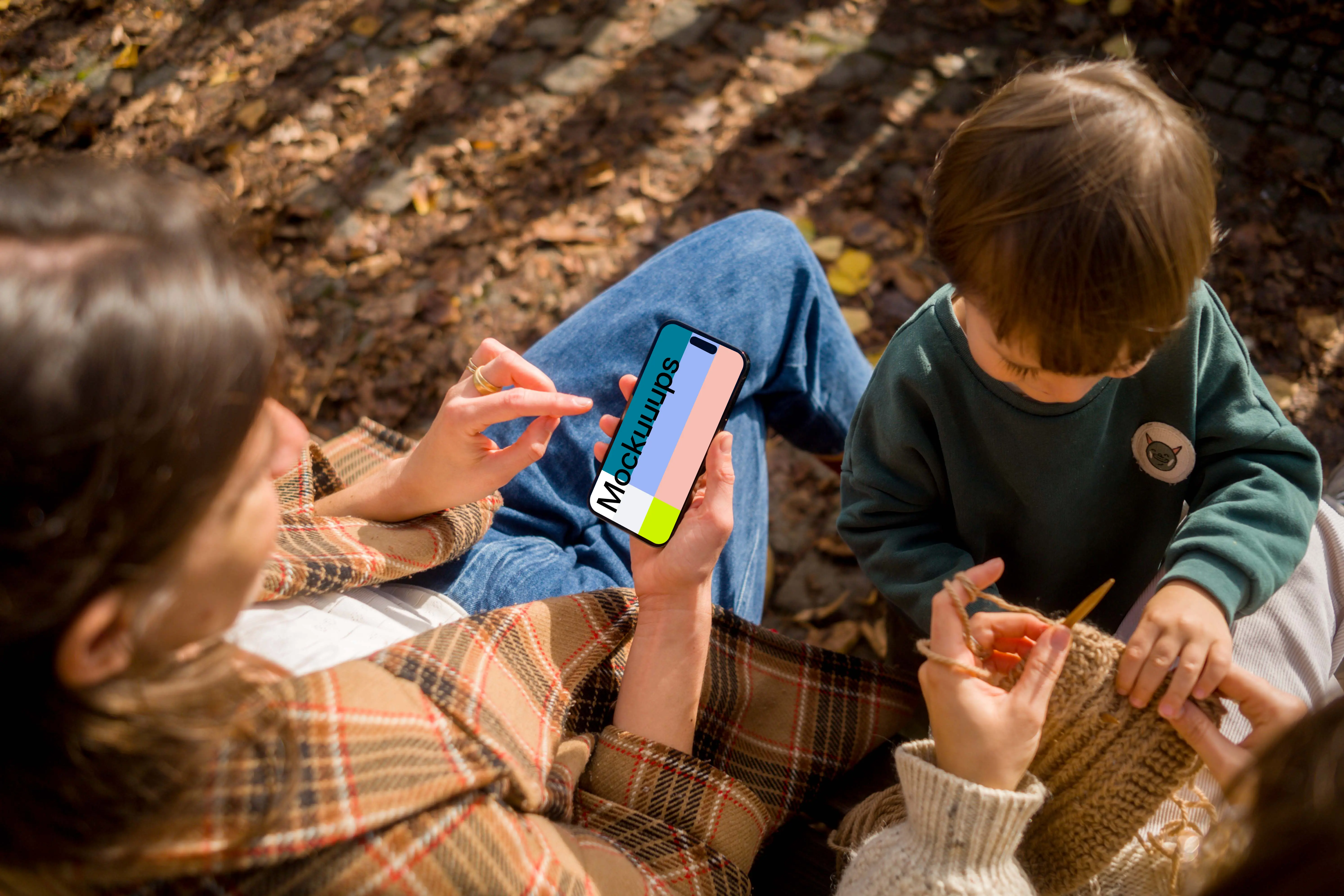 Woman typing on an iPhone 14 Pro next to the kid mockup