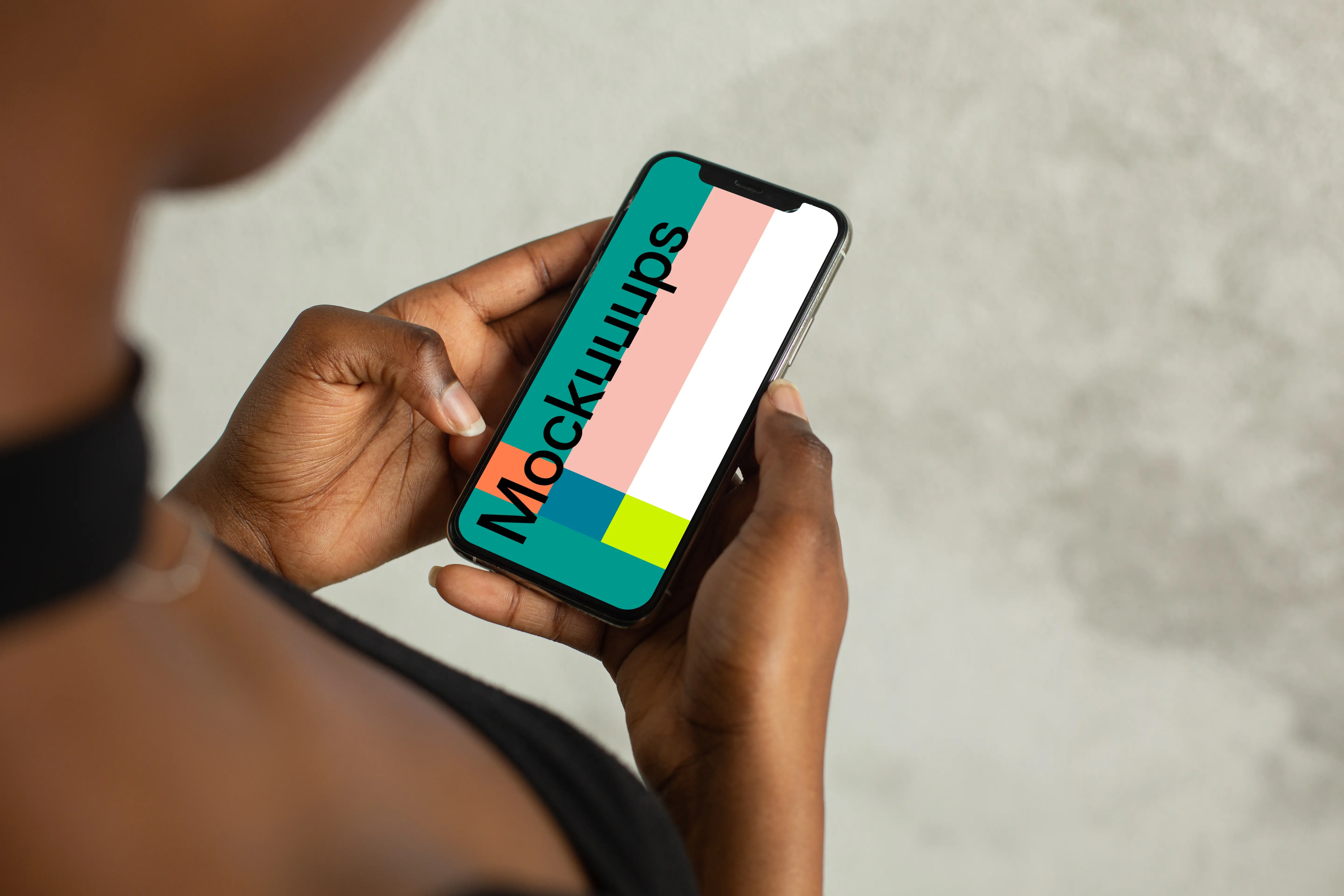 Young lady holding an iPhone 12 mockup