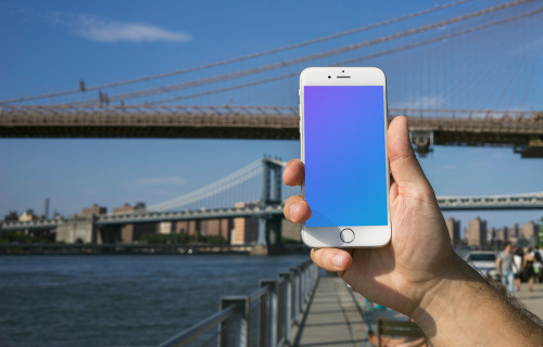 Holding iPhone 6 mockup in front of Brooklyn Bridge