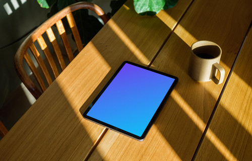 iPad Air mockup beside a cup of coffee and a plant in the background