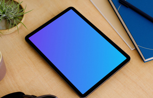 iPad Air mockup on a table beside a diary