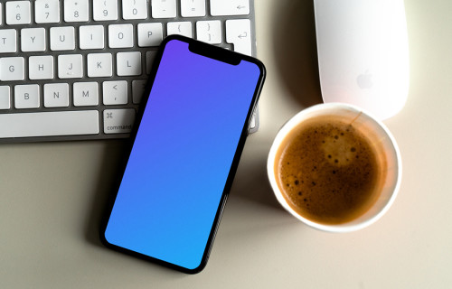 iPhone 12 mockup beside a cup of coffee