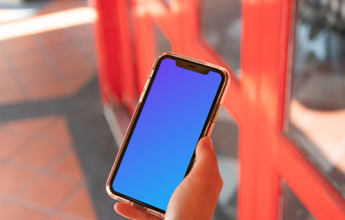 iPhone mockup help by user beside red doors
