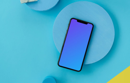 iPhone mockup on a light blue table