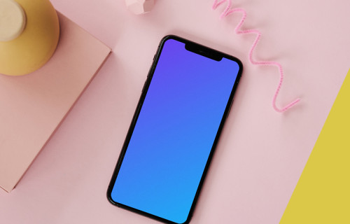 iPhone mockup on a pink table