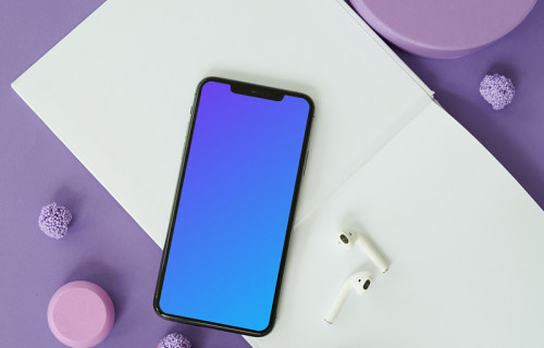 iPhone mockup on a table with a pair of AirPods at the side