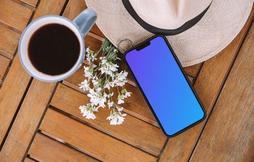 iPhone mockup with flowers and a cup of coffee