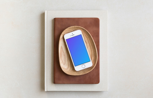 iPhone SE mockup placed on wooden plate