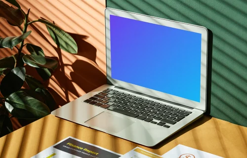 MacBook Air mockup beside a plant