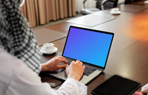 MacBook Air Mockup used by a lady on a conference table