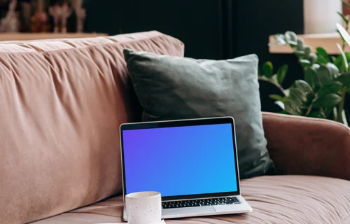 MacBook Pro mockup on a red sofa