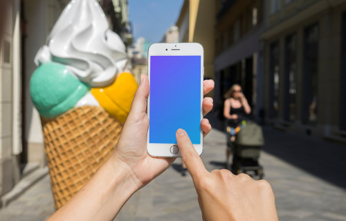 Pointing on iPhone 6 mockup in front of ice cream shop
