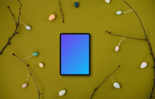 Tablet mockup among Easter eggs on branches