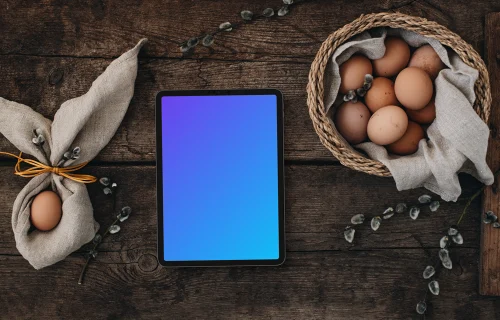 Tablet mockup among eggs for the Easter season