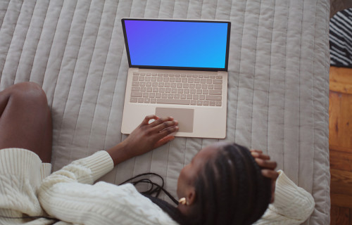 Woman working on the Microsoft Surface Laptop mockup from bed