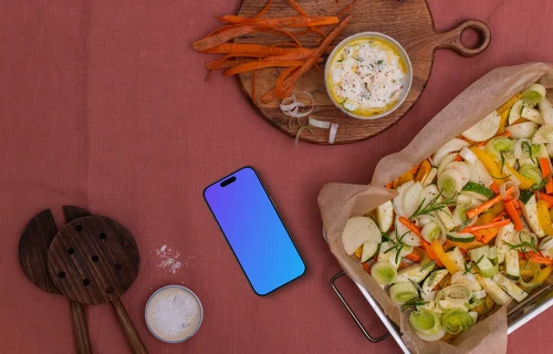 Baking pan full of vegetables and a phone mockup