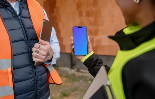 Construction engineer holding an iPhone mockup