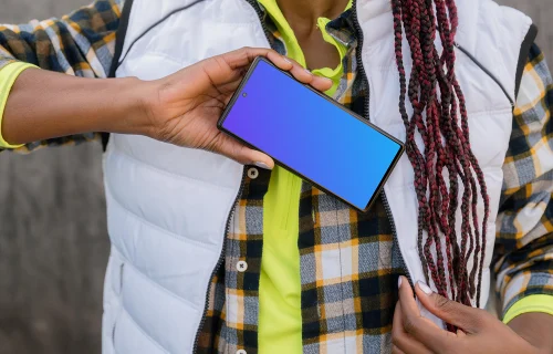 Female construction worker with a smartphone in her hand