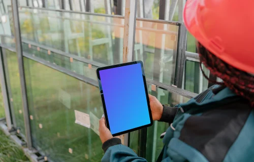 Female construction worker with an iPad in her hands