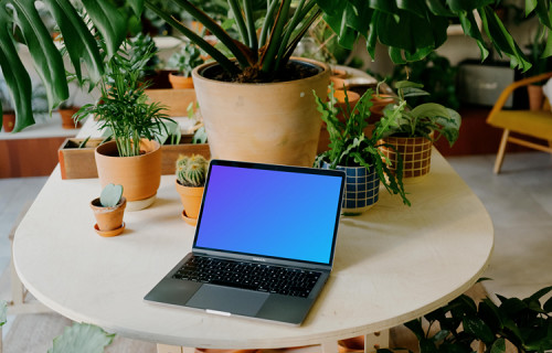 Grey MacBook Pro mockup on a round table