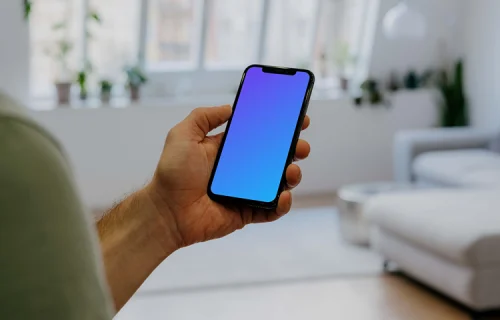 Holding iPhone 12 Pro Mockup in front of windows
