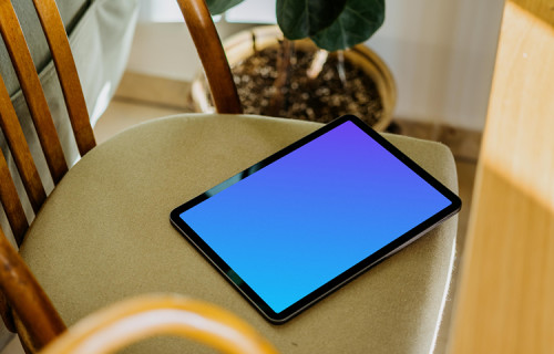 iPad Air mockup on a chair with a plant in the background